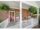 Inviting front porch with white railings, rocking chairs, and a decorative wreath at 614 Stone Village Dr, Fort Mill, SC 29708
