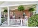 Charming front porch with brick facade, ferns, and black and white decor at 614 Stone Village Dr, Fort Mill, SC 29708