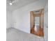 Hallway with carpet and view to hardwood flooring, neutral paint, and doors to bedrooms at 614 Stone Village Dr, Fort Mill, SC 29708