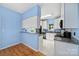 Charming kitchen with white cabinetry, stainless steel appliances, and blue accent walls at 614 Stone Village Dr, Fort Mill, SC 29708