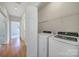 Convenient laundry room with washer, dryer, and storage shelves at 614 Stone Village Dr, Fort Mill, SC 29708