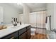 Modern bathroom featuring a stylish vanity with sleek countertops and warm wood-look flooring at 6314 Bluffton Ln, Midland, NC 28107