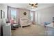 Charming Bedroom with floral accent wall, crib and ample natural light at 6314 Bluffton Ln, Midland, NC 28107