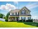 Charming two-story home featuring a landscaped yard, welcoming porch, and beautiful architectural details at 6314 Bluffton Ln, Midland, NC 28107