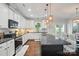 Spacious kitchen with granite countertops, stainless steel appliances, and a large center island at 6314 Bluffton Ln, Midland, NC 28107