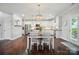 Open-concept kitchen and dining area with stainless steel appliances and hardwood floors at 6314 Bluffton Ln, Midland, NC 28107