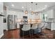 Modern kitchen featuring white cabinets, a center island with seating, and stainless steel appliances at 6314 Bluffton Ln, Midland, NC 28107