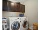 Efficient laundry area with front load washer and dryer and ample storage at 6314 Bluffton Ln, Midland, NC 28107