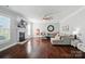 Spacious living room with hardwood floors, fireplace, and comfortable seating arrangement at 6314 Bluffton Ln, Midland, NC 28107