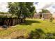 Backyard with some greenery and fence, showing neighboring homes at 6717 Ware Rd, Charlotte, NC 28212