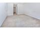 Spacious bedroom with neutral carpet and standard baseboard trim at 6717 Ware Rd, Charlotte, NC 28212