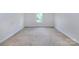 Small bedroom featuring neutral carpet and a single window view at 6717 Ware Rd, Charlotte, NC 28212
