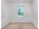Small bedroom with a single window and neutral colored carpet at 6717 Ware Rd, Charlotte, NC 28212