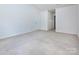 Large bedroom with neutral carpet, a door, and ample wall space at 6717 Ware Rd, Charlotte, NC 28212