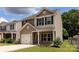 Charming two-story home featuring a one-car garage, well-maintained lawn, and dark shutters at 6717 Ware Rd, Charlotte, NC 28212