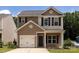 Charming two-story home featuring a one-car garage and welcoming front porch at 6717 Ware Rd, Charlotte, NC 28212