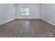 Bright and spacious living room with wood flooring and natural light from a large window at 6717 Ware Rd, Charlotte, NC 28212