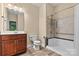 Well-lit bathroom with a vanity, toilet, and shower/tub combo with updated fixtures at 7020 Cedar Ridge Ct, Mount Holly, NC 28120