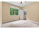 Bright bedroom with large window overlooking lush greenery, neutral paint, and carpet at 7020 Cedar Ridge Ct, Mount Holly, NC 28120