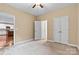 Neutral bedroom with carpet, ceiling fan, and double closet doors for ample storage at 7020 Cedar Ridge Ct, Mount Holly, NC 28120