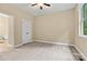 Cozy bedroom with soft carpeting, a ceiling fan, and a connecting bathroom for added convenience at 7020 Cedar Ridge Ct, Mount Holly, NC 28120