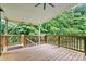 Spacious wooden deck with wood railing overlooking a lush, wooded backyard at 7020 Cedar Ridge Ct, Mount Holly, NC 28120