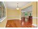 Open dining area with hardwood floors and elegant lighting fixtures at 7020 Cedar Ridge Ct, Mount Holly, NC 28120