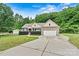 Charming brick home with an attached garage, driveway, and landscaped front yard at 7020 Cedar Ridge Ct, Mount Holly, NC 28120