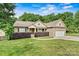 Charming brick home with well-maintained landscaping, attached garage, and inviting front porch at 7020 Cedar Ridge Ct, Mount Holly, NC 28120