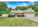 Charming brick home with well-maintained landscaping, attached garage, and inviting front porch at 7020 Cedar Ridge Ct, Mount Holly, NC 28120