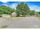Gravel driveway leading to a brick home with a separate garage and mature trees at 7020 Cedar Ridge Ct, Mount Holly, NC 28120