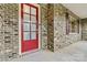 Inviting front door with glass panes and stylish brick accents at 7020 Cedar Ridge Ct, Mount Holly, NC 28120