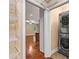 Convenient laundry area with stacked washer and dryer, plus wire shelving for storage at 7020 Cedar Ridge Ct, Mount Holly, NC 28120