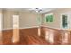 Open-concept living room flows to kitchen with hardwood flooring and natural light at 7020 Cedar Ridge Ct, Mount Holly, NC 28120