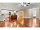 Open living space features a central island, stainless steel appliances, and hardwood floors at 7020 Cedar Ridge Ct, Mount Holly, NC 28120