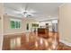 Open-concept layout connects the kitchen, living and dining areas with hardwood floors at 7020 Cedar Ridge Ct, Mount Holly, NC 28120