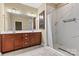 Well-lit main bathroom with double vanity, walk-in shower, and tile floors at 7020 Cedar Ridge Ct, Mount Holly, NC 28120