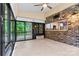 Bright sunroom with wood flooring, brick accent wall and view into the kitchen at 7020 Cedar Ridge Ct, Mount Holly, NC 28120