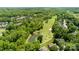 Aerial view of the neighborhood featuring lush golf course, pond, and mature tree coverage at 7245 Willow Brook Ct, Denver, NC 28037