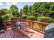 Outdoor deck with a metal table and chairs, perfect for entertaining or enjoying the backyard view at 7245 Willow Brook Ct, Denver, NC 28037