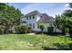 Manicured backyard featuring lush green grass, trimmed hedges and the back of the home at 7245 Willow Brook Ct, Denver, NC 28037