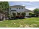 Spacious backyard with a wooden deck, mature landscaping, and privacy fence at 7245 Willow Brook Ct, Denver, NC 28037