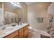 Bathroom with double vanity, decorative mirror, and tile flooring with a shower and bath at 7245 Willow Brook Ct, Denver, NC 28037