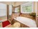 Elegant bathroom featuring a separate shower and garden tub under a window with natural light at 7245 Willow Brook Ct, Denver, NC 28037