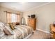 Cozy bedroom with soft carpet, natural light, a wooden dresser, and a comfy bed at 7245 Willow Brook Ct, Denver, NC 28037