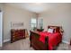 Comfortable bedroom featuring a wooden dresser, writing desk, natural light, and calm ambience at 7245 Willow Brook Ct, Denver, NC 28037