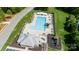 Aerial view of a community pool with slides, tables, playground, and ample seating at 7245 Willow Brook Ct, Denver, NC 28037