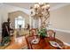 Open-concept dining room with a grand chandelier and views to the entryway and staircase at 7245 Willow Brook Ct, Denver, NC 28037