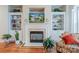 Living room fireplace with built in shelving and a TV showing the exterior of the house at 7245 Willow Brook Ct, Denver, NC 28037