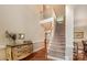 Foyer with hardwood floors, staircase, and decorative chest with stairs leading to 2nd floor at 7245 Willow Brook Ct, Denver, NC 28037